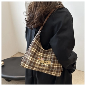 Detail of brown plaid tote bag featuring cute dog embroidery and premium stitching
