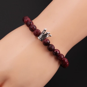 Close-up of a men's 8mm beaded bracelet featuring a silver crown and red tiger eye stones