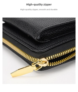 Detailed macro view of the premium gold metal zipper on black lychee leather bag