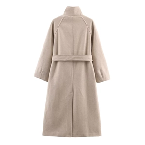 Rear view of long oatmeal wool coat featuring a waist belt and center back slit detail