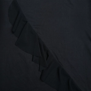 Detailed macro view of black elastic knit fabric texture with ruffle hem design details