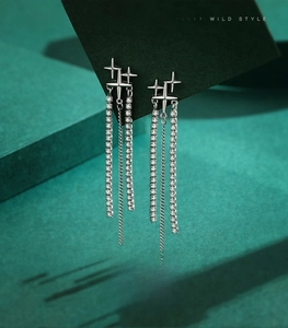 Detailed macro of S925 sterling silver tassel earrings with sparkling star and zircons