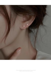 Close-up of minimalist gold cubic zirconia earrings on a model showing refined detail
