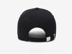 Close-up of black baseball cap back with adjustable metal buckle and embroidered eyelets