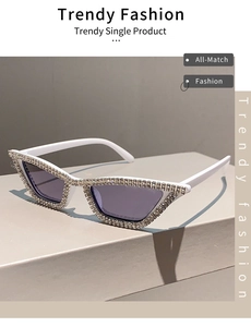 Detail of white cat eye sunglasses with shimmering rhinestones and gradient lenses