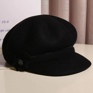 Chic black wool newsboy cap for women featuring a bow and vintage metal button detail