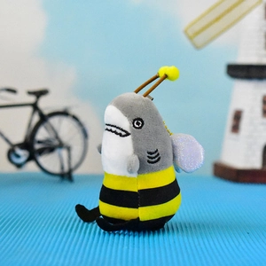 Detailed close-up view of a funny shark bee hybrid plush keychain with glitter wings