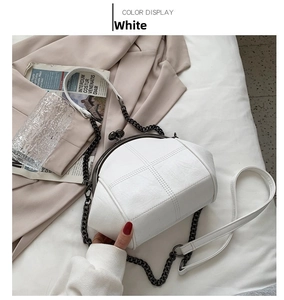 Detailed view of white quilted crossbody shell bag with retro metal clasp and chain strap