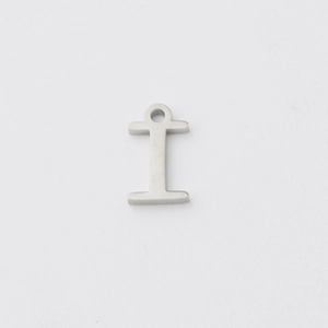 Macro shot of silver mirror polished stainless steel letter I alphabet pendant