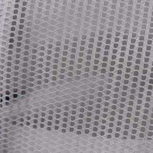 Detailed close-up of breathable white mesh fabric on the trucker cap back panel