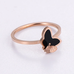 Minimalist rose gold butterfly ring with black enamel wings and frosted texture details