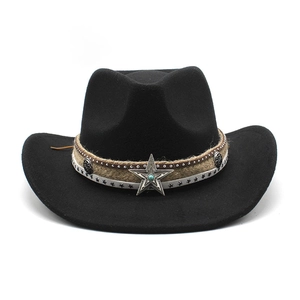 Detail of vintage black wool felt cowboy hat with turquoise star badge and woven band