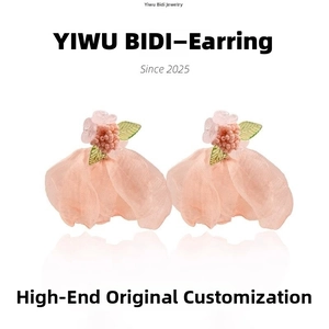 Detailed macro of pink floral earrings with delicate crystal tassels and soft organza petals