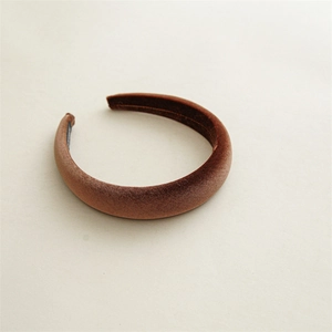 Close-up of thick brown velvet headband showing premium plush texture and padded design