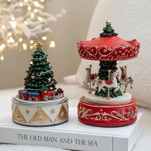 Festive resin Christmas carousel and tree music boxes for cozy holiday tabletop decor