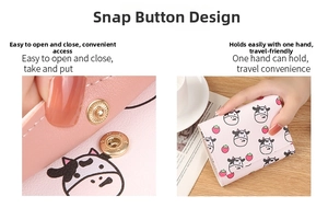 Pink trifold cow print wallet with snap button closure and compact handheld design