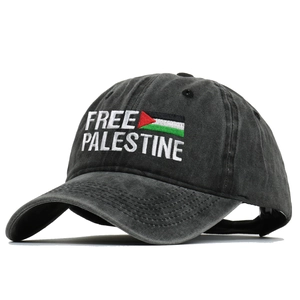 Macro detail of Free Palestine embroidery on washed black vintage cotton baseball cap