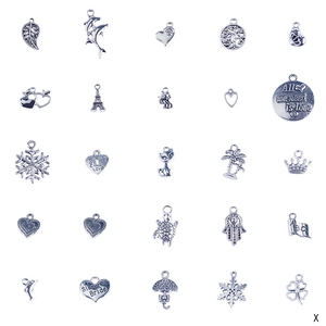 Detail showing various silver alloy charms including hearts, stars and Eiffel Tower symbols