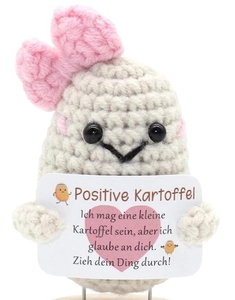 Macro detail of hand-knitted beige potato doll with a small pink bow and German message card