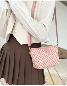 Detail of the pink floral embossed square bag with golden hardware and matching wide strap