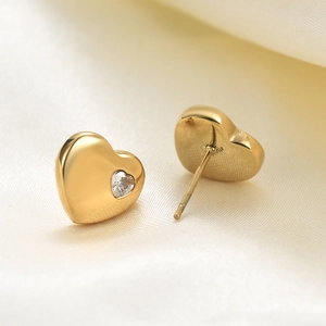 18K gold plated heart stud earrings with 12mm cubic zirconia inlay on silk background