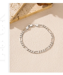 Detailed macro view of S925 sterling silver Figaro chain bracelet with 925 stamp engraving