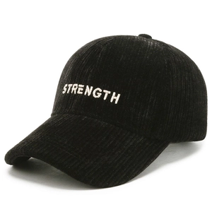 Black corduroy baseball cap with white STRENGTH embroidery from a side-angle view