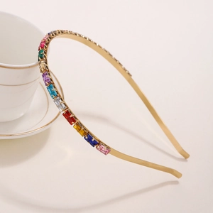 Minimalist gold headband with colorful rectangular rhinestones on a white background