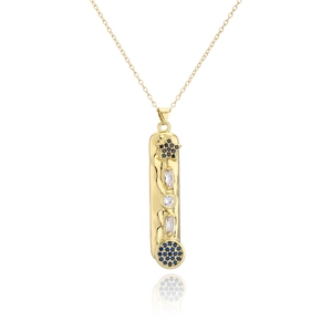 Macro shot of gold-plated geometric pendant with blue enamel evil eye and sparkling crystals