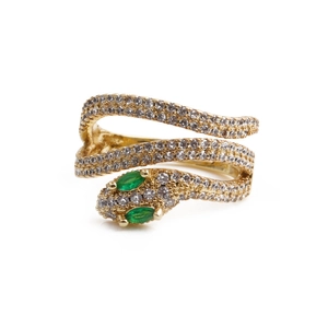 Macro detail of golden snake ring featuring sparkling white zircons and green crystal eyes