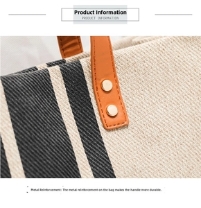 Close-up of orange leather handles with golden rivet reinforcement on striped canvas bag