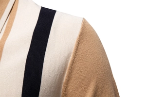 Detail of shoulder stitching and striped knit pattern on men's polo shirt in beige and black