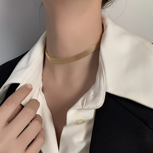 Flat woven titanium steel choker necklace in gold finish worn by a fashion model