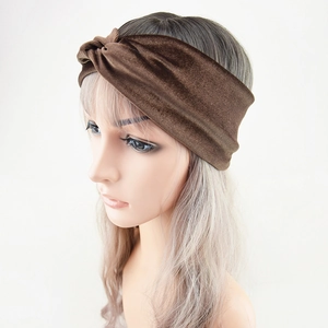 Detail of a brown velvet twisted headband showing the soft texture and fit on a model