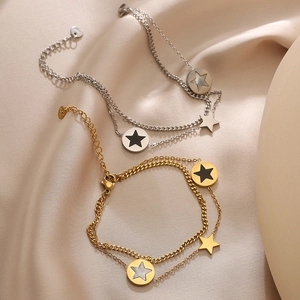 Double-layered star bracelet in gold and silver steel with shell and oil drip charms