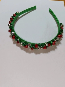 Christmas headband with red and silver metal bells on a green ribbon base festive design