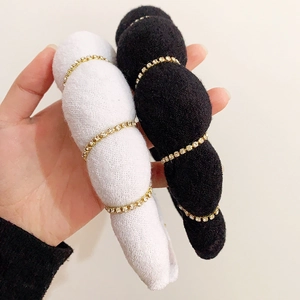 Detail of soft towel fabric headbands in black and white with sparkling rhinestone rings