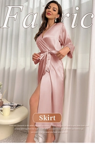 Detail of silk-like satin robe featuring a side slit and tie waist in dusty pink