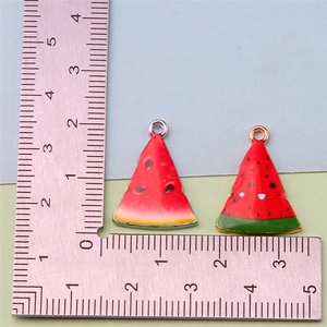 Detail view of watermelon alloy charms with a ruler showing the 2.3cm height and width