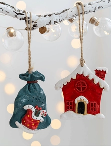Detail of resin Christmas gift bag and cottage ornaments with hemp ropes for festive decor