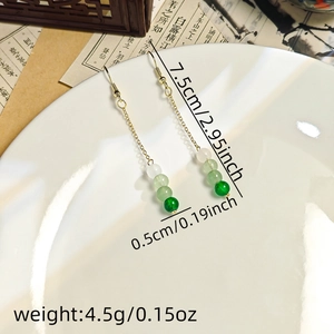 Detailed view of long beaded tassel earrings showing length 7.5cm and green bead size