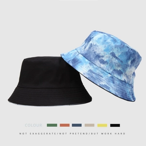 Reversible tie-dye bucket hat in blue and black colors for outdoor sun protection