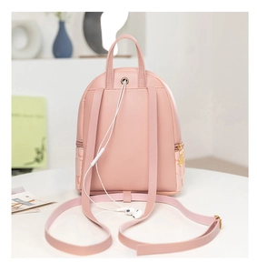 Detail view of pink mini backpack with functional headphone jack and adjustable straps