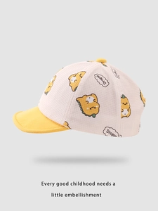 Detailed view of the yellow cartoon dinosaur print and Drogon bubble on a kids baseball cap