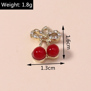 Macro shot of cherry pendant with red beads and bow detail, size 1.6cm by 1.3cm