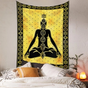 Chakra wall tapestry hanging over bed with warm lighting creating a zen atmosphere