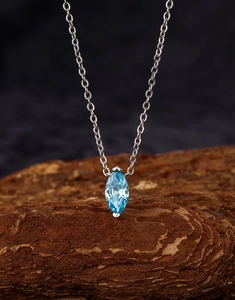 Detailed macro view of S925 sterling silver necklace with marquise sea blue zircon pendant