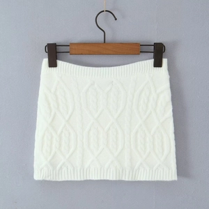Detail of white cable knit mini skirt with soft texture on a wooden clothes hanger
