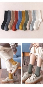 Close-up of ribbed cotton knee-high socks in multiple colors with a warm indoor lifestyle view