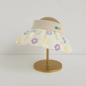Detail of girls' sun hat featuring colorful 3D MISS letters and floral pattern on brim